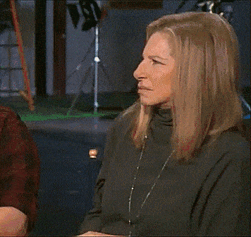Gif of Barbara Streisand looking aruond confused