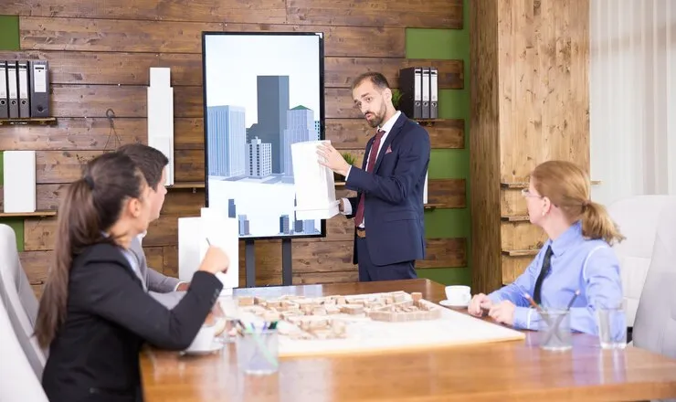 real estate professionals presenting model