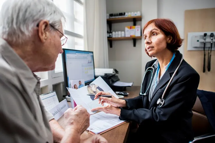 doctor consulting with elderly patient
