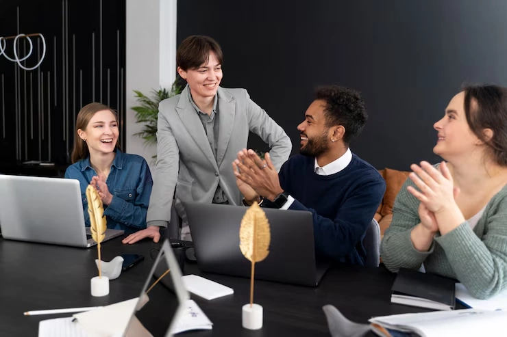 Business team celebrating successful executive media training session with applause in modern office