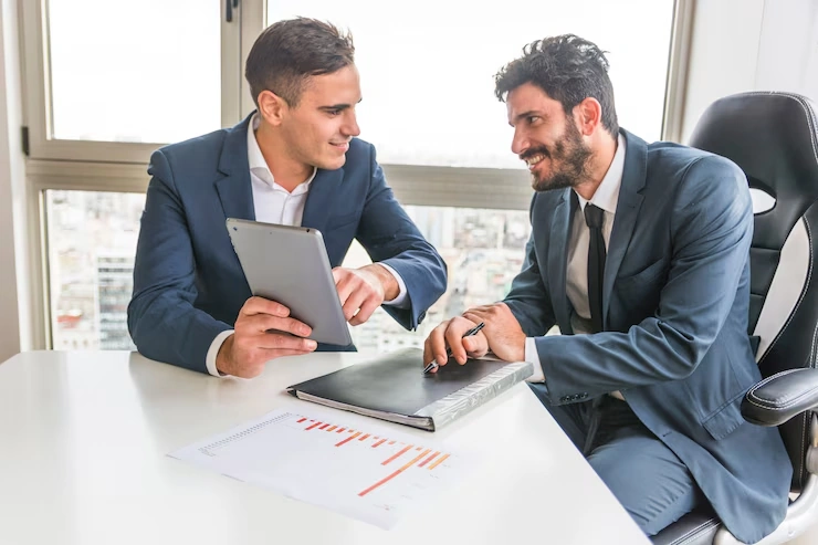 Business executives reviewing ongoing reputation management data and analytics in professional consultation